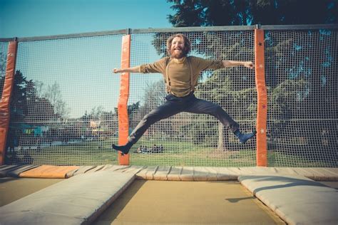 Premium Photo | Man jumping on trampoline at playground