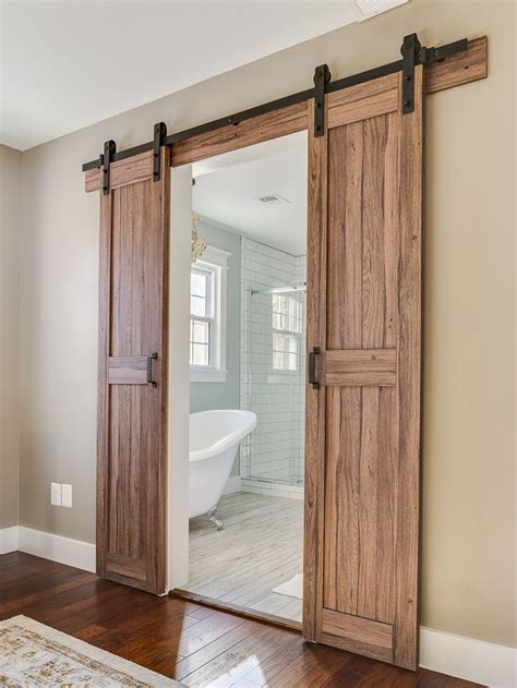 Barn doors leading into master bathroom in a modern farmhouse #ModernBathroomBarnDoors ...