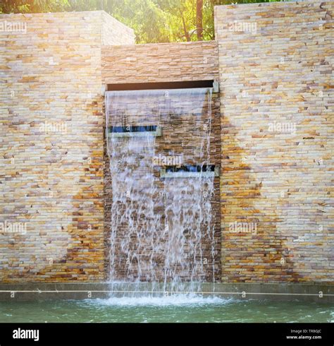 Stones brick and waterfall wall and water pond beautiful design ...