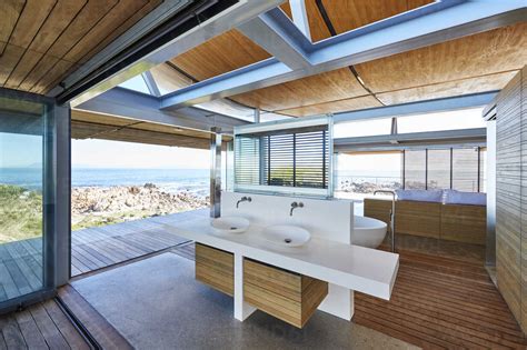 Modern luxury home showcase bathroom open to patio with ocean view stock photo