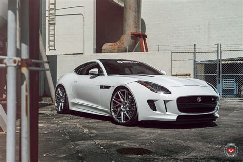 a white sports car parked in front of a building