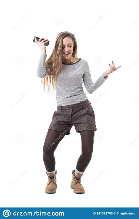 Happy Excited Young Woman Dancing and Listening Music on Mobile Phone Loud Speaker. Stock Photo ...