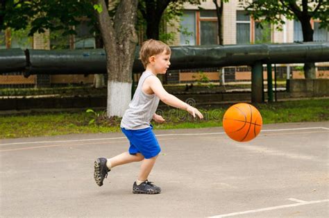 Little Boy Playing Basketball Stock Photo - Image of alone, childhood ...