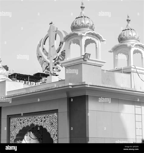 Khanda Sikh holy religious symbol at gurudwara entrance with bright blue sky image is taken at ...