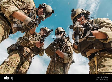 Low angle view of U.S. Army Rangers pointing weapons to the camera ...