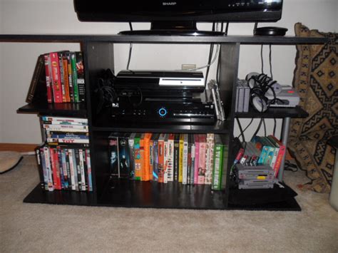 $10 - TV Stand | Black TV stand. Sturdy. Items on the shelve… | Flickr