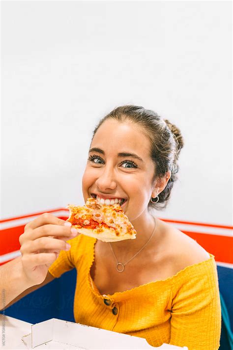 "Happy Teen Girl Eating Pizza" by Stocksy Contributor "VICTOR TORRES ...