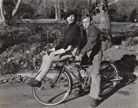 Carole Lombard and Donald Haines ride a bike