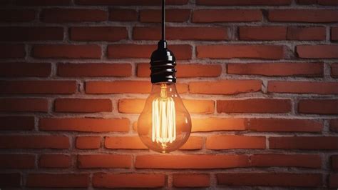 Premium AI Image | Glowing antique light bulb illuminates brick wall ...