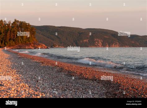 Sunset over the shoreline and waves on Lake Superior at Lake Superior Provincial Park, Ontario ...