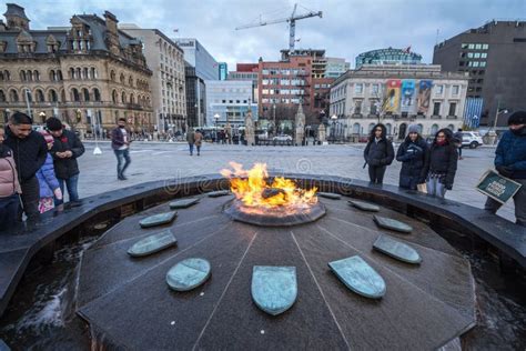 Centennial Flam, in Front of Canadian Parliament, with Tourists Warming ...