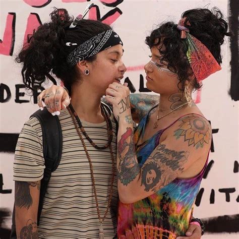 two young women standing next to each other with tattoos on their ...