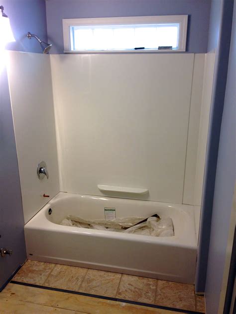 Tub-surround in and floor going in…5x7 foot bathroom. 8x41" glass block window above tub ...