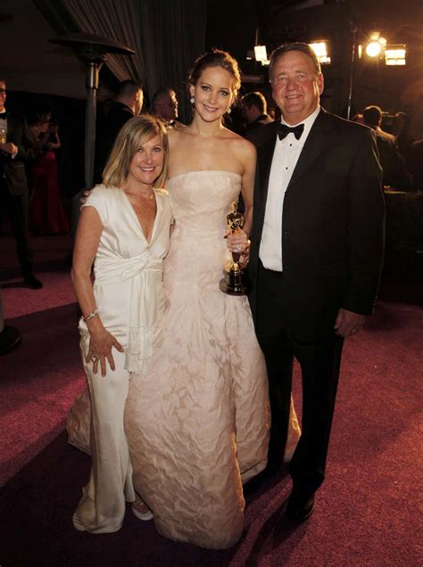 Jennifer Lawrence poses with her parents after she won the Oscar for best actress following the ...