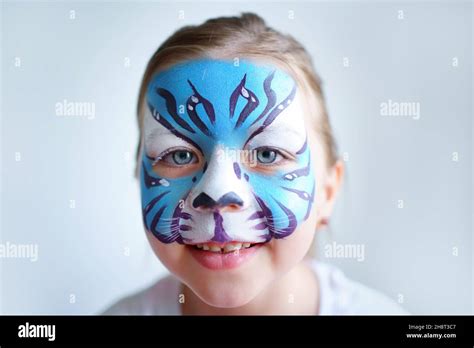 Girl aqua makeup in the form of a blue water tiger zodiac on a white background, concept symbol ...