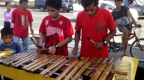 Amazing Filipino music using a self-made bamboo instrument by a father and son along Manila bay ...