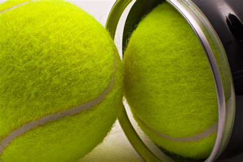 Yellow tennis balls out of black container | Two tennis ball… | Flickr