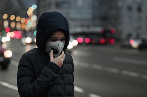 Premium Photo | Child with air pollution mask traffic in the background