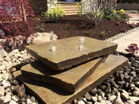 Natural slab stone, drilled and plumbed in for a naturalistic garden fountain