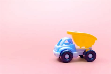 Premium Photo | Truck toy model car on pink background, space for text