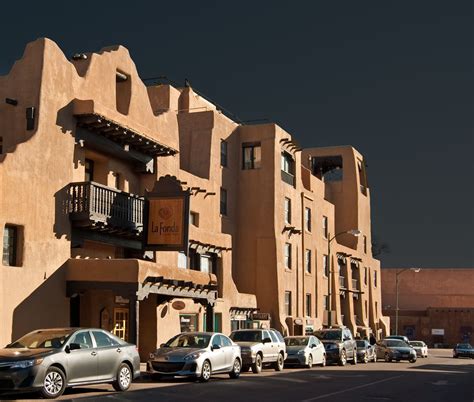 several cars parked in front of an apartment building