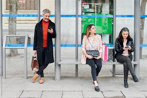 "People Waiting For A Bus" by Stocksy Contributor "Ivan Gener" - Stocksy