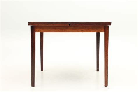 Small dining table with extensions in rosewood. Designed by Kai Winding and manufactured by ...