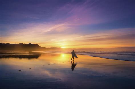 Surfer In Beach At Sunset Photograph by Mikel Martinez de Osaba | Fine Art America