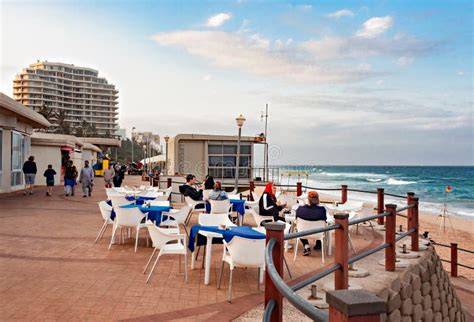 Tourists Enjoying Lunch at a Restaurant on the Promenade at the Beach in Umhlanga Rocks ...