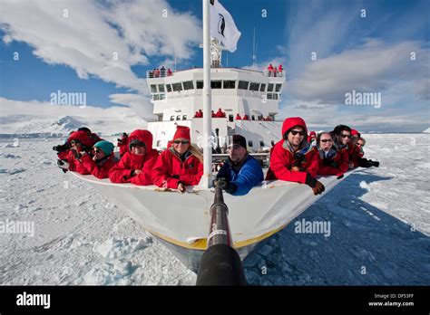 Guests from the Lindblad Expedition ship National Geographic Explorer on the bow enjoying ...