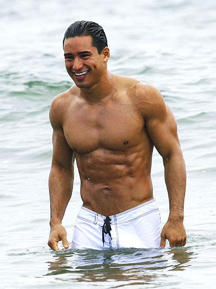 SHIRTLESS ACTORS : Mario Lopez shirtless trunk clad on the beach smiling away