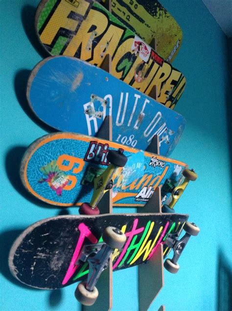 several skateboards mounted to the side of a blue wall