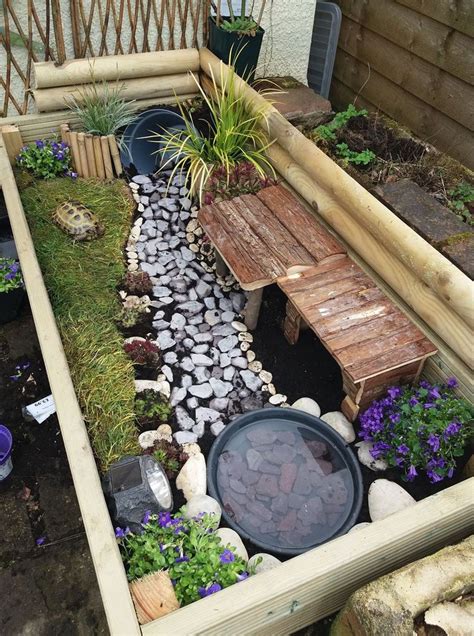 a small garden with rocks and plants in the center, along with a wooden ...