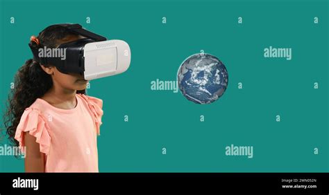Biracial child with a VR headset stands before a floating graphic of Earth Stock Photo - Alamy