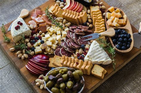 Festive cheese and charcuterie board with brie, salami, blue cheese ...