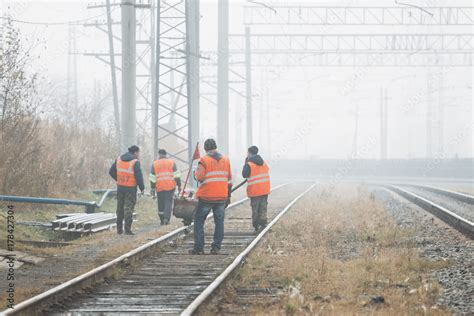 Railroad workers maintaing railways Stock Photo | Adobe Stock