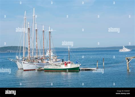 Bar Harbor Maine harbor with whale watching tourist boats on water with ...