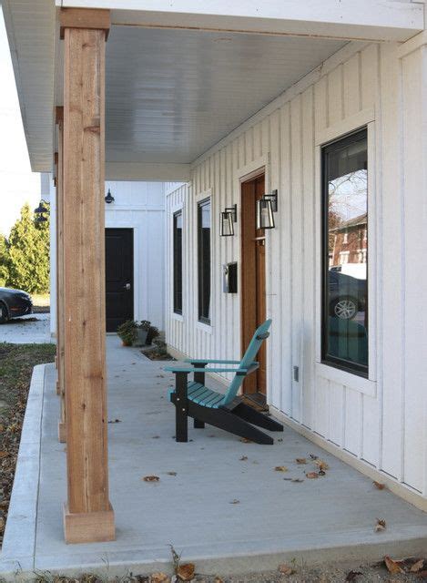 a porch with a bench on the side of it