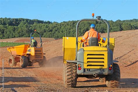 Dump trucks on a road construction site Stock Photo | Adobe Stock