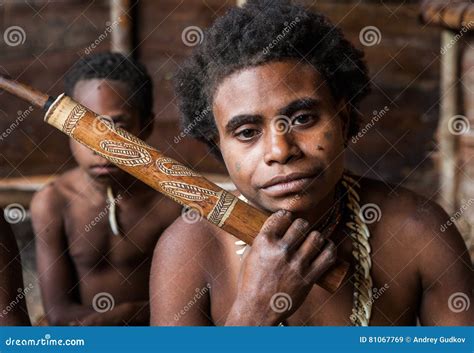 Korowai Tribe Woman Smokes a Traditional Pipe. Tribe of Korowai Kombai ...