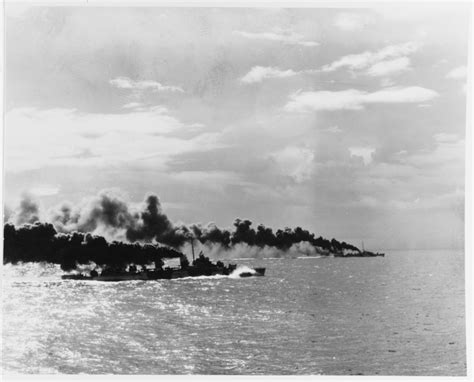 Battle of Leyte Gulf, October 1944. USS Herman (DD-532) and a destroyer-escort lay a smoke ...