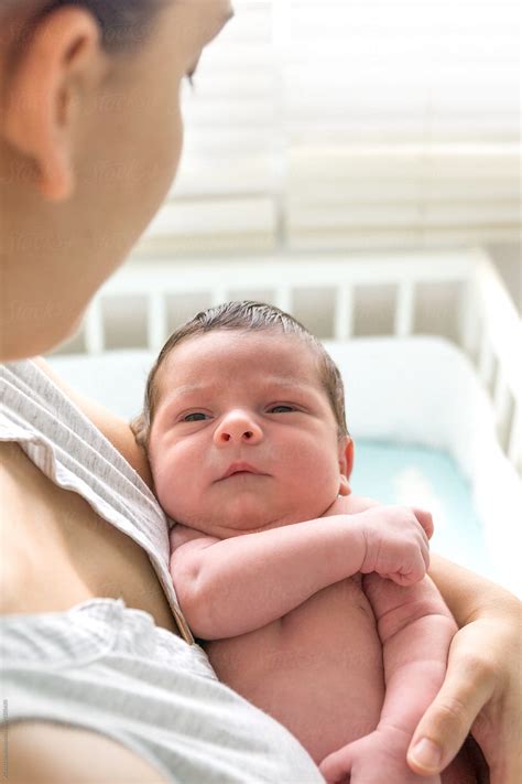 "Young Mother Holding Her Newborn Baby In Her Arms Looking At Him" by ...