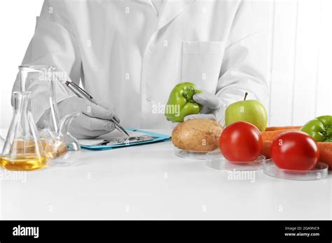 Scientist examines vegetables in laboratory Stock Photo - Alamy