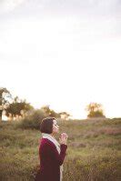 Woman Praying in Field