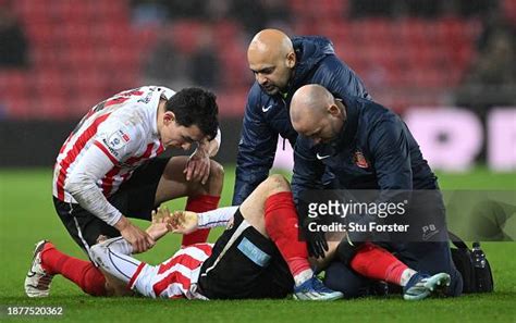 Sunderland captain Luke O' Nien checks on the injury to team mate ...