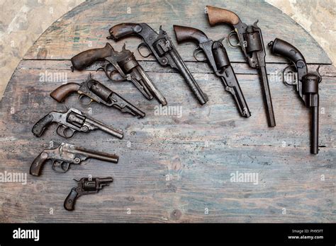 High resolution image of historical guns and pistols on a vintage wood background in an exhibit ...