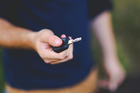 Woman in Yellow Shirt Driving a Silver Car · Free Stock Photo