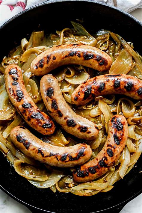 Simmered in beer with caramelized onions, this bratwurst recipe is a traditional German meal ...