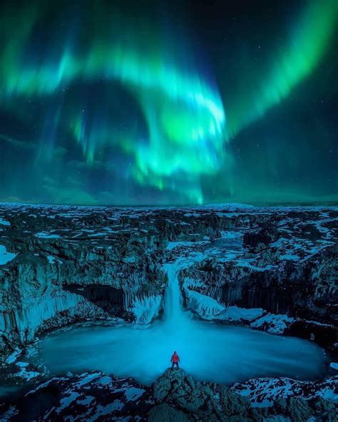 Aurora Borealis sweeping over the landscape of Iceland🌌⁣ Photo by ...