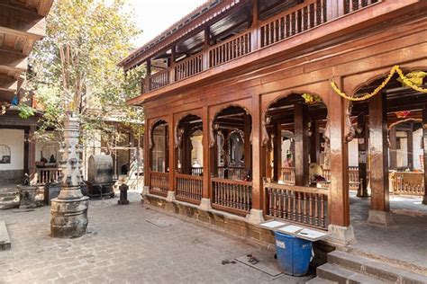 an old building with wooden pillars and balconies